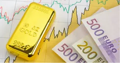 Billets de banques et lingot d'or sur fond de graphiques économiques